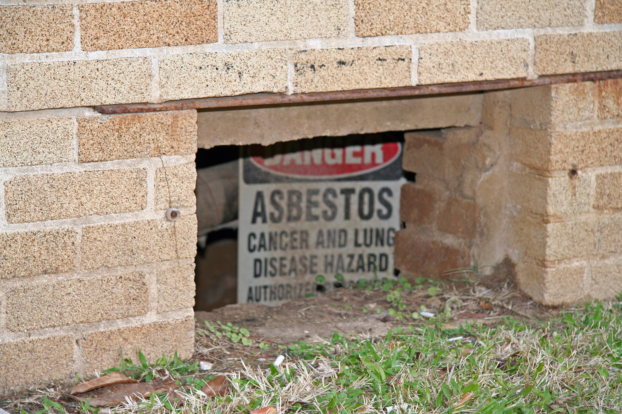 Asbestos sign in basement of building