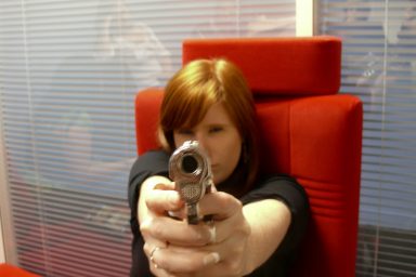 Woman pointing handgun